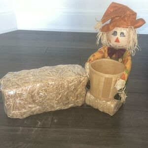 Scarecrow figurine with straw Bale